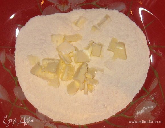 Сливочное масло нарезать кубиками и добавить в муку. Хорошо растереть в крошку.