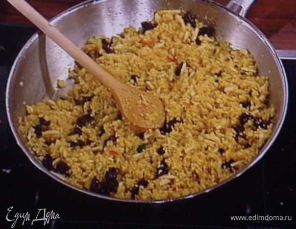 Бульон закипятить, залить им кускус. Добавить изюм и паприку.  Дать кускусу настояться и впитать в себя всю жидкость. Миндаль подрумянить на сухой сковородке. 