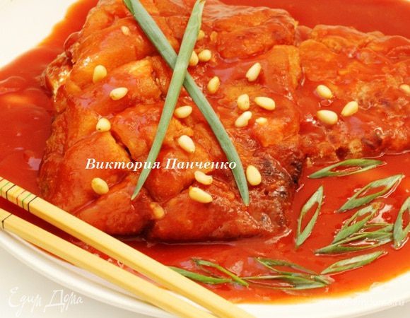 Выложить обжаренное филе на большое блюдо, сверху обильно полить кисло-сладким соусом, посыпать кедровыми орехами и зеленым луком. 