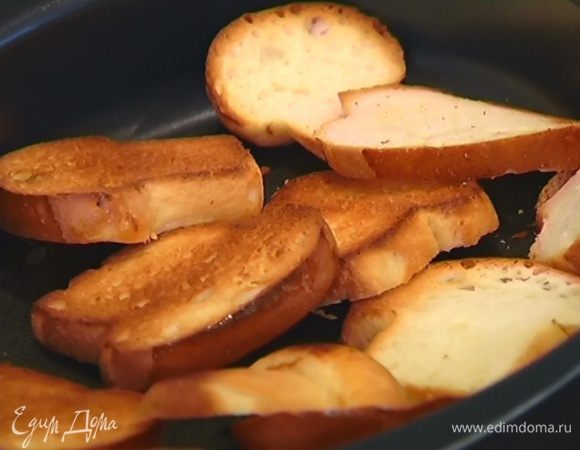 Булочки нарезать ломтиками, выложить в небольшой противень и отправить в разогретую духовку на несколько минут: одна сторона должна получиться золотистой, а вторая — остаться мягкой.