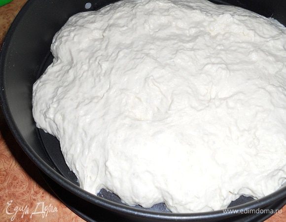 Теперь  ложкой перемешиваем тесто, чтобы оно осело, перекладываем в форму, накрываем пленкой или полотенцем и ждем, когда тесто увеличится втрое в объеме.
