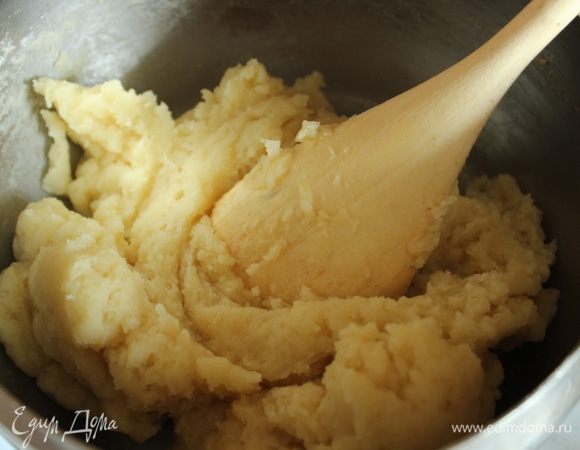 Как только вода закипит, всыпать муку и непрерывно мешать деревянной лопаткой, пока тесто не загустеет.