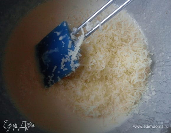 Твердый сыр натереть и добавить к яичной смеси.