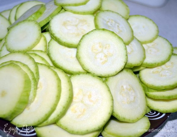 Кабачки почистить и нарезать тонкими кружками.Чем тоньше дольки,тем вкуснее получается готовое блюдо.