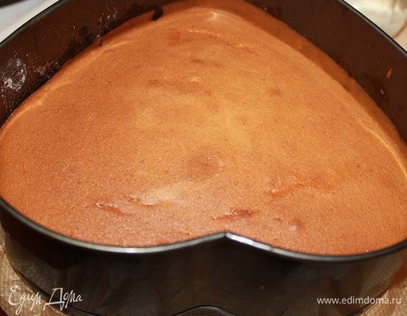 Молоко с маслом нагреть, чтобы растопить сливочное масло.  В два этапа влить молоко в тесто (получается средней густоты). Перемешивать лопаткой (ни в коем случае миксером) не более 15 секунд. (Более длительный замес может привести к получению плотного теста - тогда бисквит будет малопористый и плотный) Выложить в форму d20-22 см и выпекать 15-18 минут в разогретой до 190 градусов духовке. Готовность проверить зубочисткой - должна остаться сухой и чистой. 