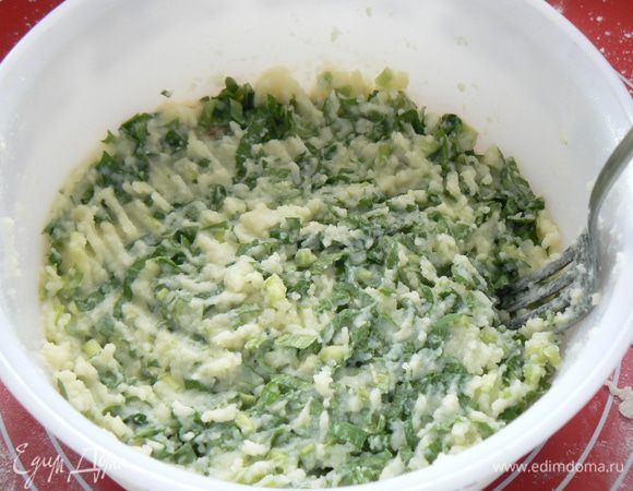 как только замесили тесто, приготовьте начинку: порежьте зелень и смешайте с картофельным пюре.