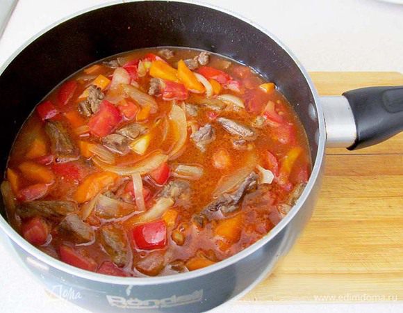 Затем положите в сотейник помидоры и томатную пасту. Если паста и помидоры очень кислые, то можно добавить сахар, чтобы выровнять вкус. Залейте водой и тушите 10 минут.