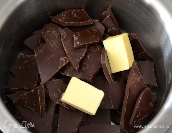 Поломать на кусочки 250 г шоколада и поставить его таять на водяной бане с 30 г масла.