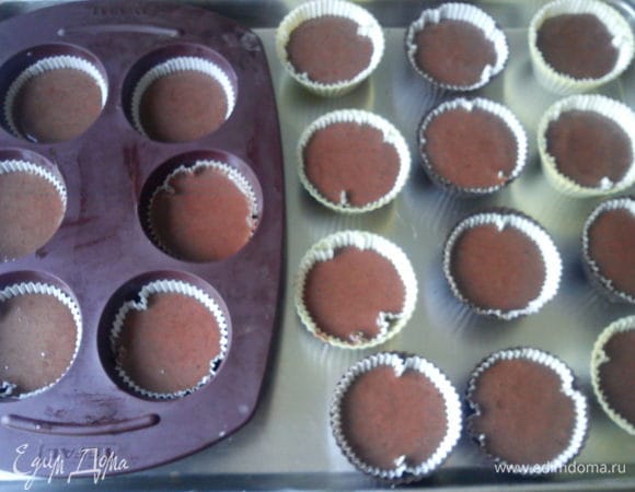 В формы для кексов вложить бумажные стаканчики заполнить их чуть выше половины. Выпекать в заранее разогретой до 200 С духовке 20-25 минут. Можно проверить деревяной шпажкой