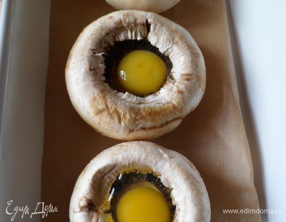 Заполняем сырыми яйцами, в каждую шляпку по одному.