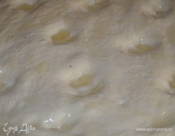 в тесте делаем 10 углублений и смазываем чесночным маслом