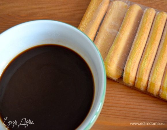 Подготовить заранее сваренный кофе. По желанию, слегка подсахарить. Подготовить печенье Савоярди. Кстати, если найти такое печенье для Вас не представляется возможным, его можно заменить на тонкий бисквитный корж, приготовленный заранее по Вашему любимому рецепту. После из бисквита вырезать кружочки, соответствующие по размеру стаканам (креманницам), в которых Вы будете подавать десерт! И дальше — все как с печеньем.