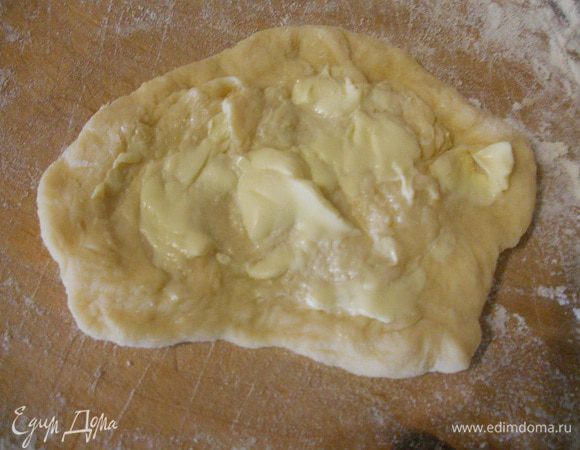 Каждый кусочек размять руками, промазать размягченным маслом и свернуть в рулетик.