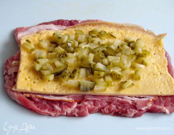 На яичный блинчик выложите нарезанные огурчики.