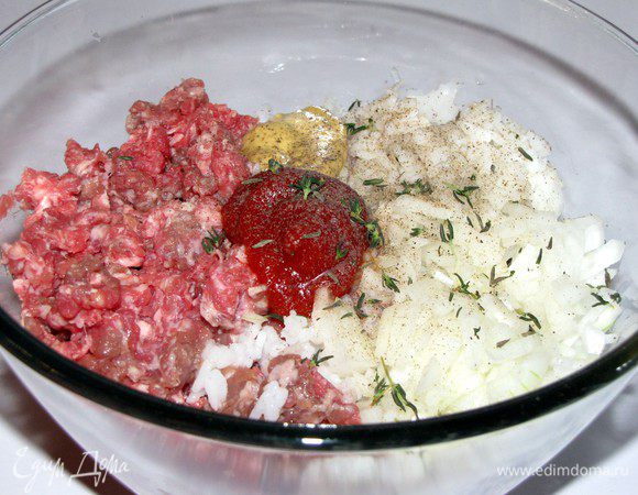 В фарш добавить мелко-рубленную луковицу,рис, горчицу, кетчуп, тимьян. Посолить, поперчить и хорошо перемешать.