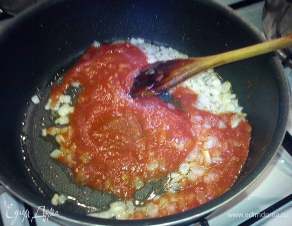 К  луку добавить томатную пасту и перемешать