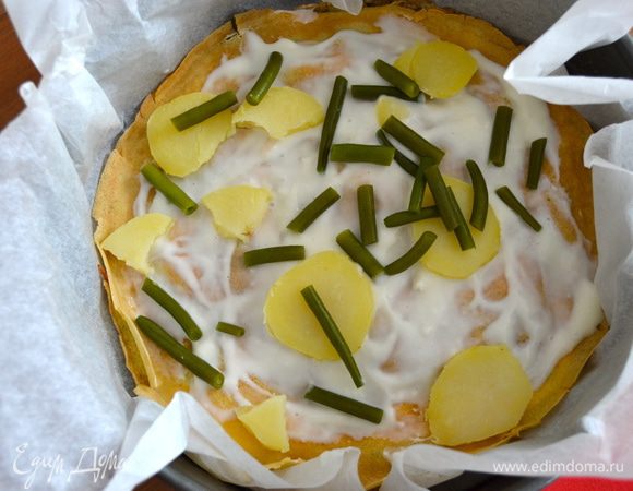 Форму для выпечки застелить пекарской бумагой. Далее кладем блин, смазываем его слегка соусом бешамель, выкладываем сверху кусочки картофеля и фасоль.