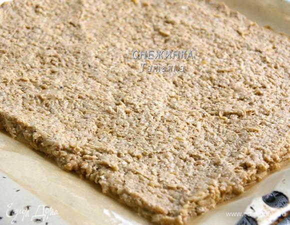 На противень кладём бумагу, смазываем растительным маслом. Распределяем тесто в виде прямоугольника, высотой около 0,5 см.