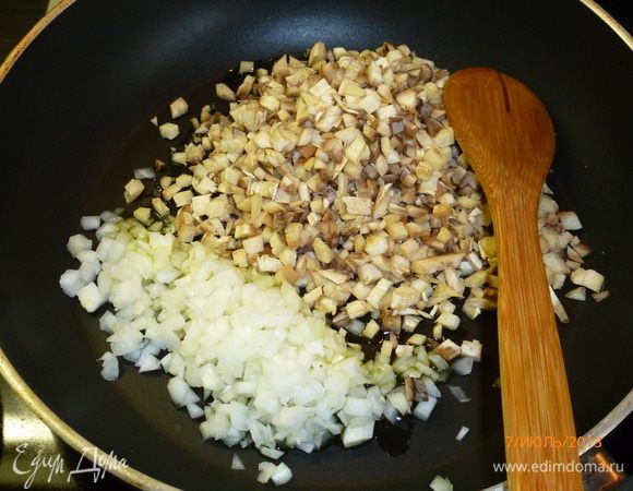 Мелко порезать ножки грибов и лук, обжарить на сковороде с небольшим количеством масла.