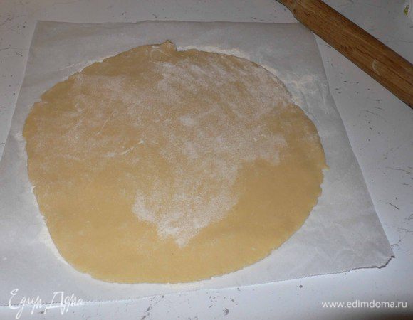 Раскатываем на пекарской бумаге два диска диаметром около 22  и 24 см. Обмазываем  маслом и обсыпаем мукой  невысокую форму.  
