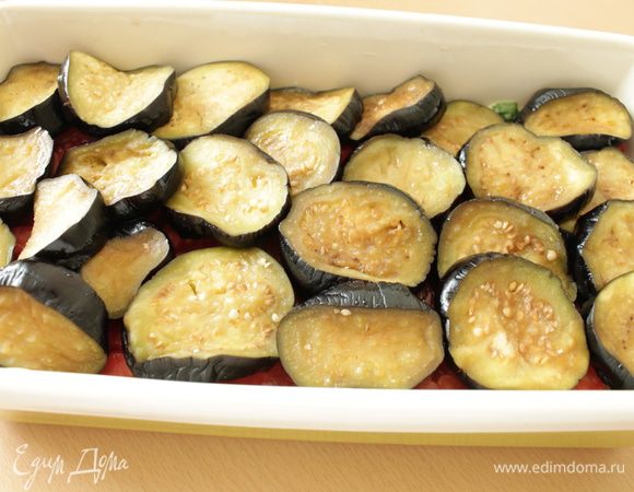 Баклажаны слегка отжать, распределить ровным слоем.
