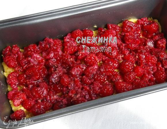 Форму для кекса слегка смазываем маслом. Выкладываем в форму половину теста. Распределяем малину.