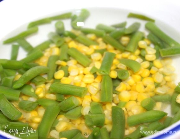 Пока запекается рыба, можно приготовить салат. Если фасоль и кукуруза не консервированные, то в кипящую, подсоленную воду опустить фасоль и варить в течении 2-3 минут. Затем добавить зёрна кукурузы и варить ещё пару минут. Готовые овощи переложить в воду со льдом на 5 минут.