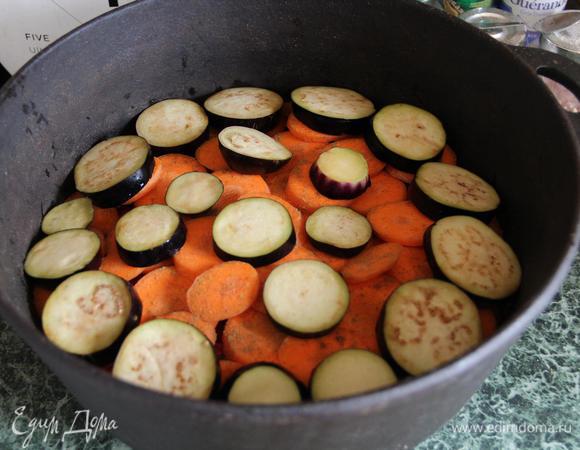 Поверх моркови — слой баклажанов. Я их добавила, потому что люблю. Можно и без них. Еще советую добавить кабачки. Принцип такой: чем дольше готовятся овощи, тем ниже они должны лежать. Помидоры не в счет, их дело — пускать сок. Скорее по привычке, чем по необходимости, я посолила баклажаны за полчаса до готовки. В любом случае, не забывайте солить слои!  Но не забывайте также, что наши овощи будут уменьшаться в размерах.