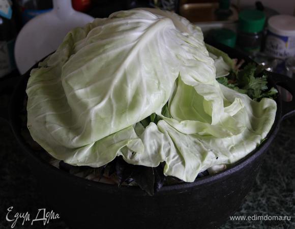 Укройте казан капустными листьями. 