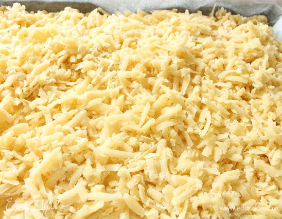 Достать тесто из морозильной камеры,натереть его на крупной терке и распределить поверх  начинки.Выпекать пирог при 170 градусах 40-45 минут,до золотистого цвета поверхности пирога и начинка должна схватиться.Выключить духовку и оставить пирог при закрытой дверке еще на 10 минут.Затем достать пирог,накрыть его полотенцем и полностью остудить.По желанию можно посыпать затем сахарной пудрой.Приятного вам аппетита!