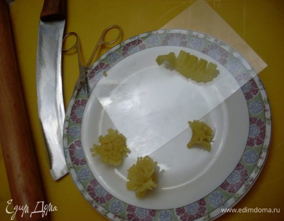 Одуванчики - потребуются скалка, маникюрные ножницы, нож и твердая пленка (была в наборе с марципаном). Раскатать кусочек марципана, нарезать полоски разной ширины (для серединки и краев одуванчика). С ровной стороны полоски сделать надрезы - лепестки. С каждой полоской работать по очереди, они хорошо клеятся. Скручивать полоски в рулончики, придавая форму цветов одуванчиков, если рвется, ничего страшного, приклеивать кусочками - так даже живее выходит. 
Сделать стебельки и листья - они по форме схожи с детскими рисунками елки, только книзу сужаются. Из вишен и марципана сделать божьих коровок.