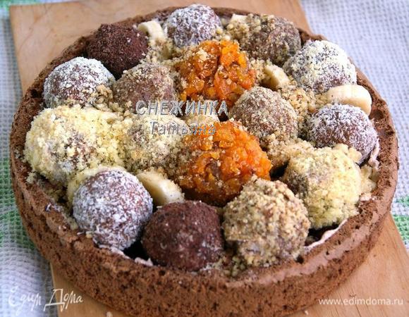 Теперь заполняем «коробочку» полученными «конфетами», чередуя их, одну-две «конфеты» оставляем для верхнего слоя. Места между шариками заполняем кусочками банана, шоколада и грецкого ореха. Чем плотнее уложить, тем лучше поведёт себя торт при разрезании.