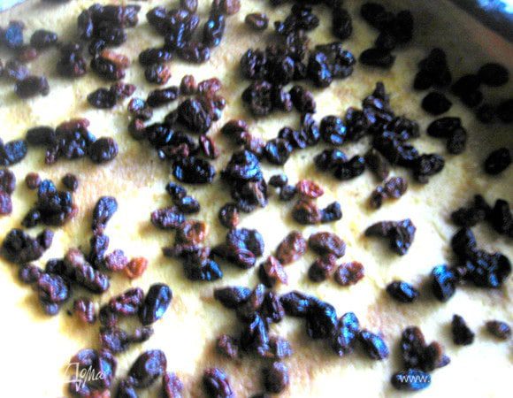 Рулет отделяем от пергамента сразу, сворачиваем с помощью полотенца,чтобы придать форму, затем разворачиваем осторожно и посыпаем по всей поверхности изюмом... Остатки бренди тоже сбрызгиваем на тесто!