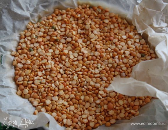 Постелим пергамент или пленку для выпечки. Насыпем туда фасоль (а еще лучше рис). Разогреем духовку до 170 градусов. На центральный уровень поставим форму с тестом. Выпекаем до легкого подрумянивания по краям. Примерное время 20-25 минут. Убираем пергамент с наполнителем.. Поставим форму с тестом обратно в духовку минут на 10-15.  Вытащим из духовки. Сначала охладим в форме, затем вытащим и полностью охладим на решетке.