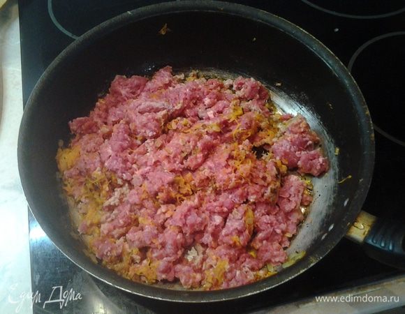 К луку с морковью добавить фарш. Немного потушить. Посолить и поперчить по вкусу