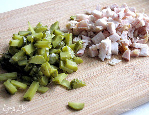 Мясо нарежьте небольшими кусочками. Огурцы нарежьте небольшими кубиками.