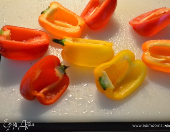 Перцы осторожно разрезаем на половинки, очищаем от семян.