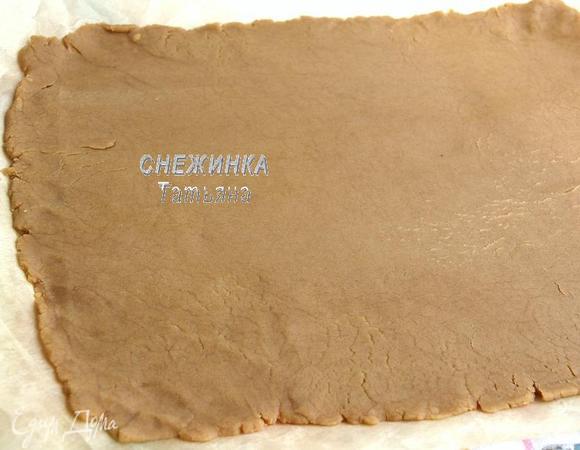 Спустя 30 минут, берём тесто. Раскатываем его в прямоугольник прямо на пергаментной бумаге, толщиной где-то 0,5-0,8 см, не очень тонко, чтобы не рвалось, но и не толсто.

