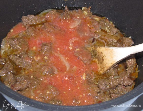 Добавить томаты в казан, снова перемешать. Увеличить огонь и тушить 30 минут. Затем посолить и поперчить. По рецепту добавляется по 0,5 ч. л. черного и красного перца, но я этого не делала, т. к. аджика была достаточно острой. Перемешать, оставить на 3 минуты.