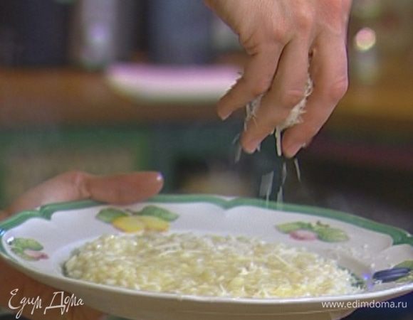 Готовое ризотто разложить по тарелкам и посыпать оставшимся сыром.