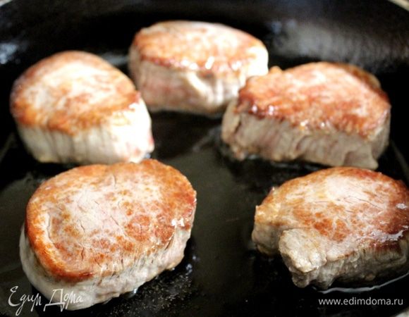 Свиную вырезку нарезать на медальоны и быстро обжарить на горячей сковороде на растительном масле до золотистого цвета. Присыпать мясо солью, перцем, переложить в жаропрочную форму и поставить в духовку, разогретую до 170-180*С на 10-15 минут.