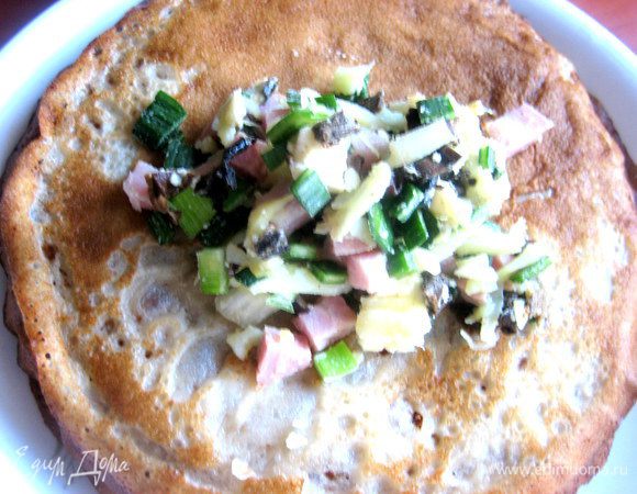 Кладём по столовой ложке начинки на каждый блинчик...