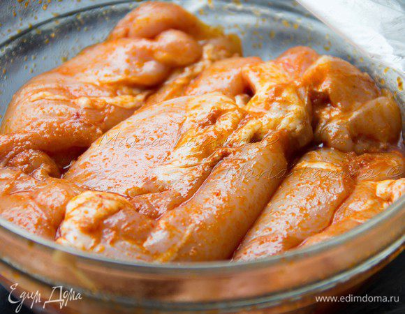 Первым делом надо разделать и замариновать курицу. Для этого отделаем куриное мясо от кости и кожи, можно купить уже готовые бескостные бедра или же заменить на филе. Курицу солим, кладем в миску, добавляем паприку, красный перец, соус табаско и оливковое масло. Как следует перемешиваем и оставляем на полчасика. 