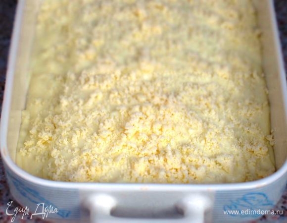 Сверху выложить соус Бешамель, посыпать оставшемся пармезаном.....