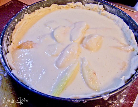 Форму для запекания смазать сливочным маслом, присыпать мукой. Раскатать тонко тесто, выстелить дно и стенки формы. Выложить на тесто веером все груши (можно в несколько слоев). Залить кремом.