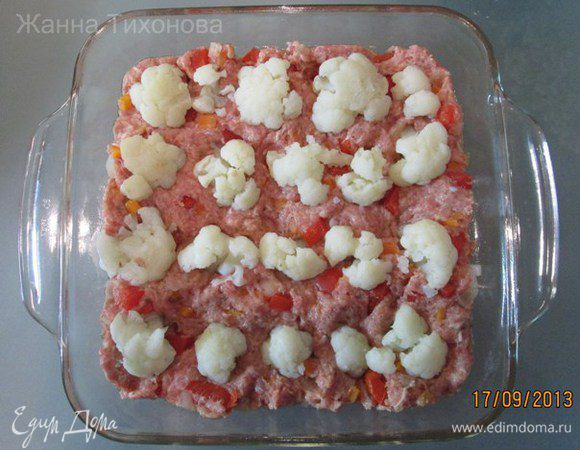 Духовку разогреть до 180 град. 
Форму смазать маслом. Выложить часть фарша.
"Посадить" цветную капусту (рядками, как на грядке!).
