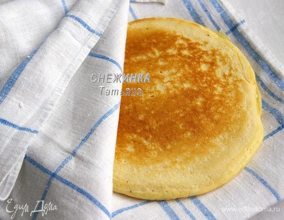 Выпекайте с другой стороны. На тарелку для блинов положите одну половину кухонного полотенца, на нее — блин и накройте второй половиной до следующего блина.