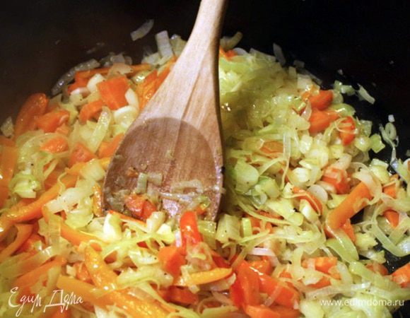 Лук тонко нарезаем и обжариваем до мягкости в кастрюле с толстым дном с небольшим количеством масла. Сюда же добавляем нарезанный кольцами стебель сельдерея, морковь, затем мелко порезанный чеснок, специи. Добавляем вино и готовим несколько минут, пока основная часть жидкости не испарится.