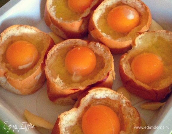Вбиваем аккуратно в каждую булочку сырое яйцо...