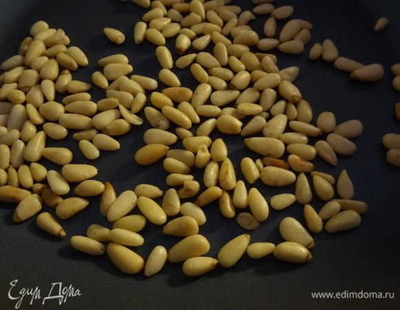 Пока помидоры в духовке, поджариваем на сковороде без масла кедровые орешки.